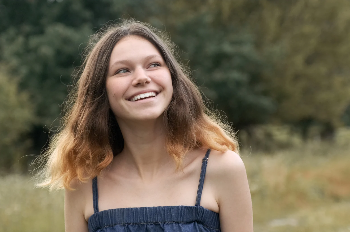 teen girl smiling and reflecting