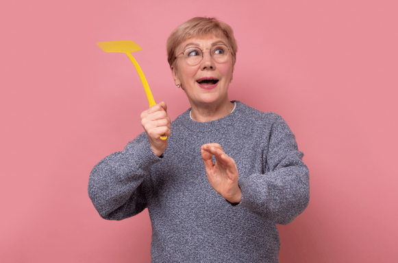 smiling woman holding fly swatter