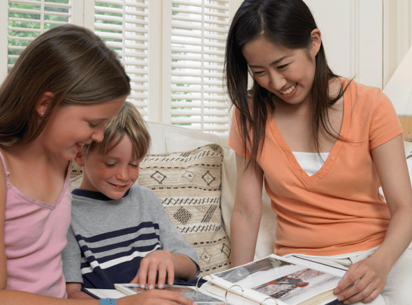 kids and Asian girl looking at photos