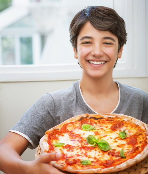 smiling Italian boy with pizza