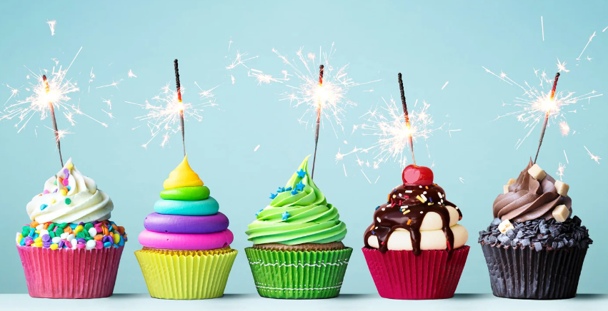 row of cupcakes with sparklers