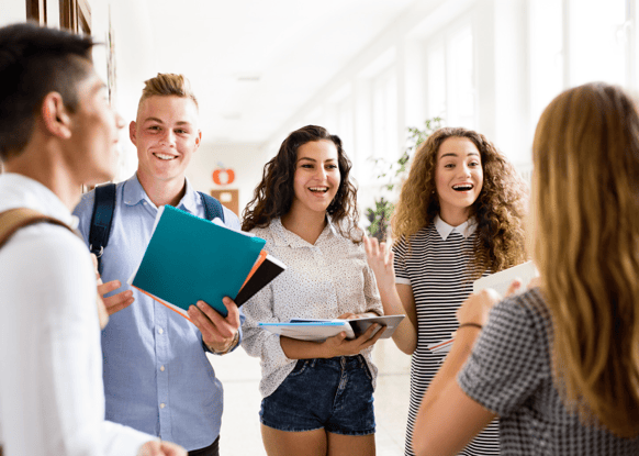 high school students talking in the hall