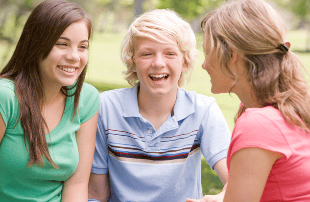 three teens talking and smiling