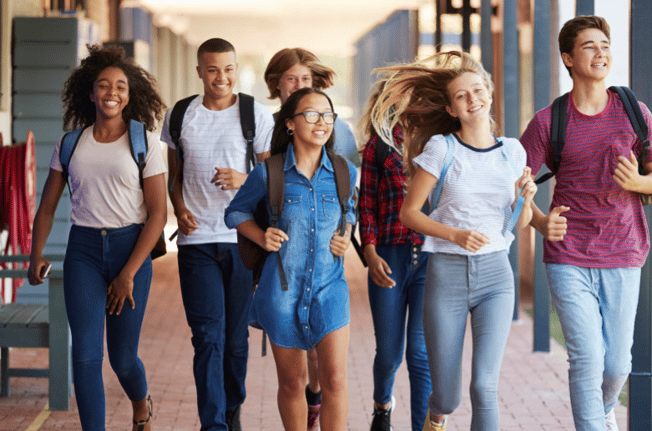smiling teens walking down the hall