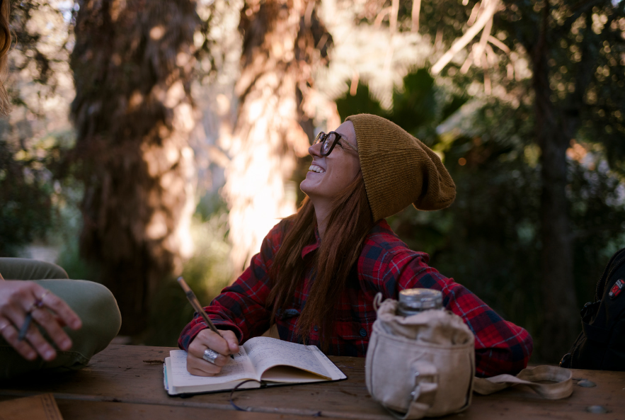 girl journaling in forest