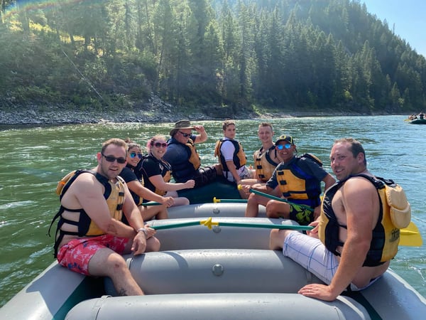 group of people on raft floating the river