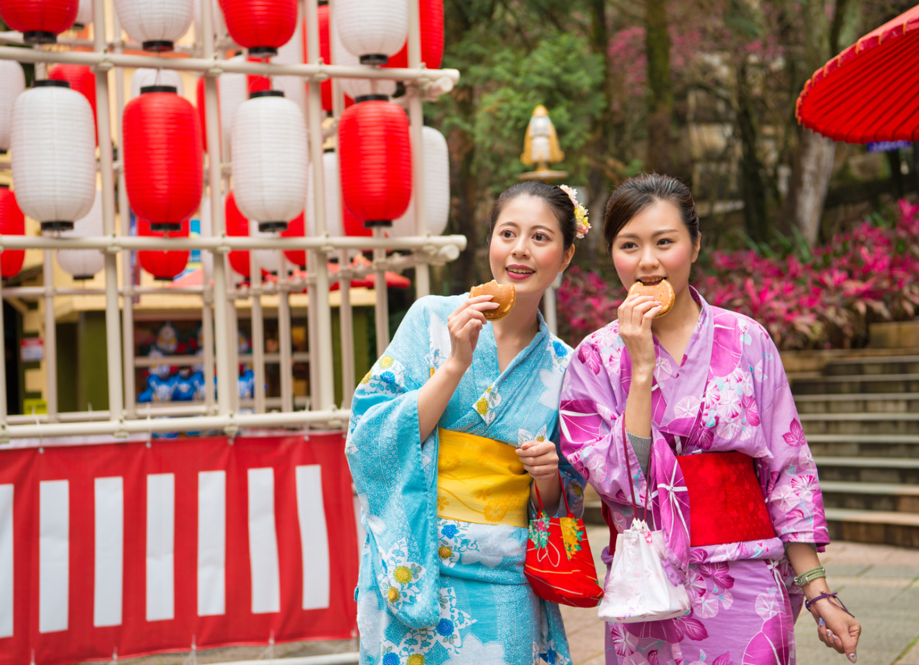 two Japanese women with lanterns behind