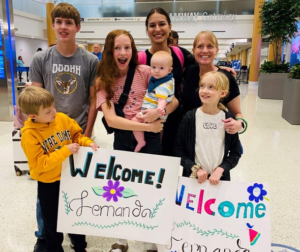large family with welcome signs