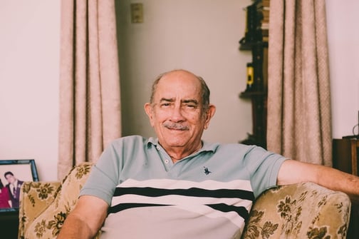 older man sitting in living room