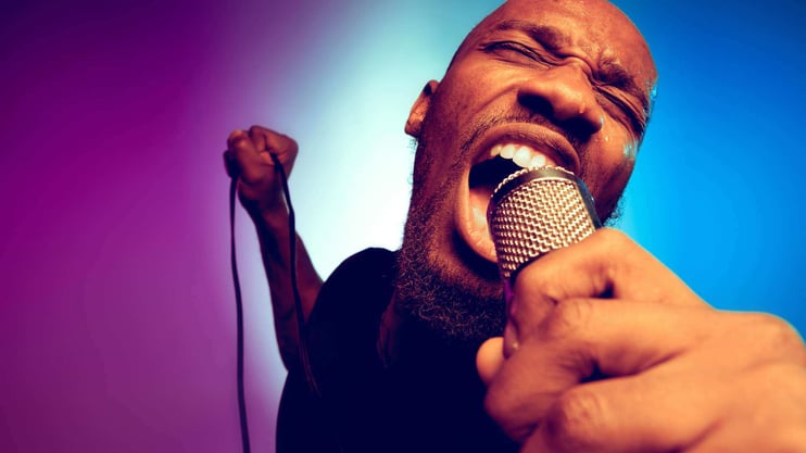 man singing into a microphone