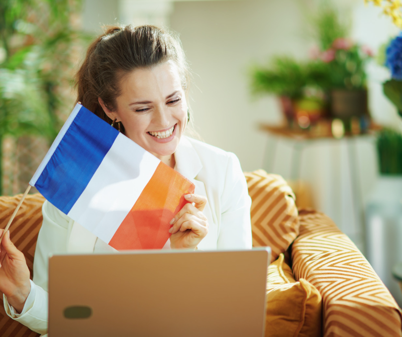 smiling woman holding French flag
