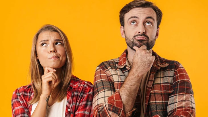 middle aged couple posing in thinking positions