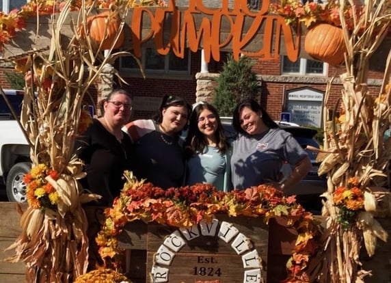 mom and daughters at pumpkin patch