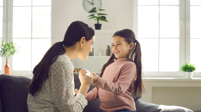 mother talking to her small daughter