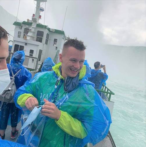 Nicolas in rain poncho in front of Niagara Falls