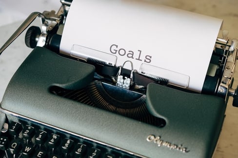 old fashioned typewriter with sheet of paper and the word goals