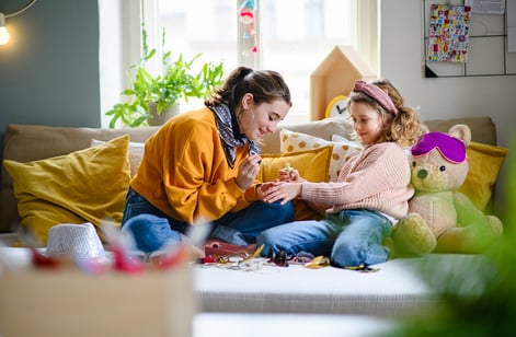 teen girl painting young girl's nails