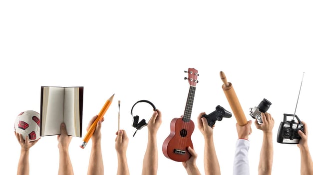 people holding up hobby items against a white background