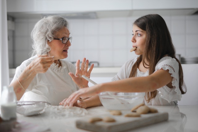 grandmother and grandaughter making cookies together