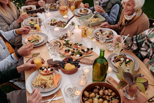 family eating Italian food around large table