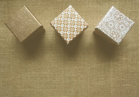 decorative gold gift boxes on a gunny sack background