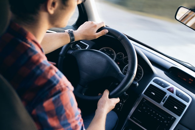 a young man driving a car