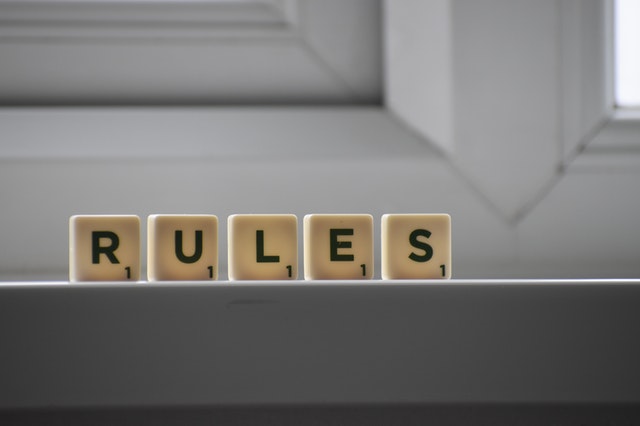 scrabble pieces spelling the word rules