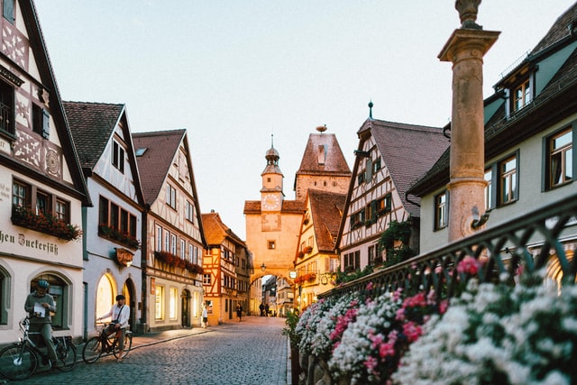 a cobblestone street in Germany lined with traditional shops and houses