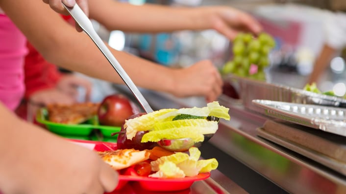 school cafeteria line with food on trays