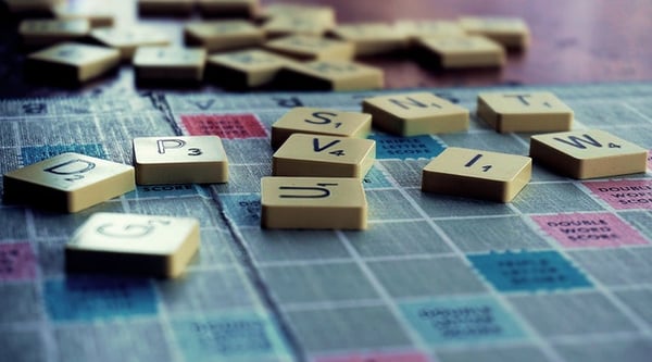scrabble tiles scattered on the game board