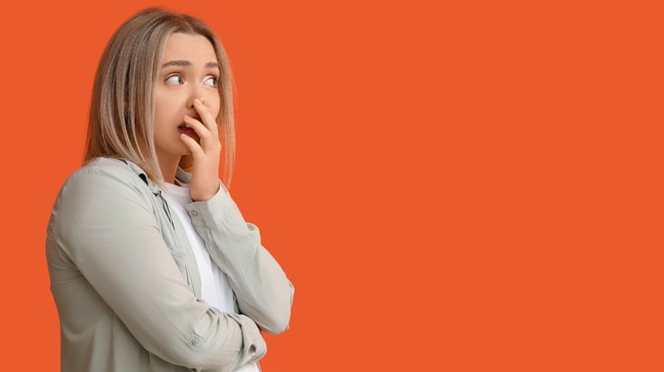 shocked teenage girl with hand over mouth