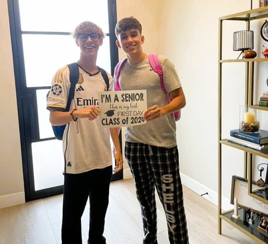 two teen boys holding I'm a Senior sign