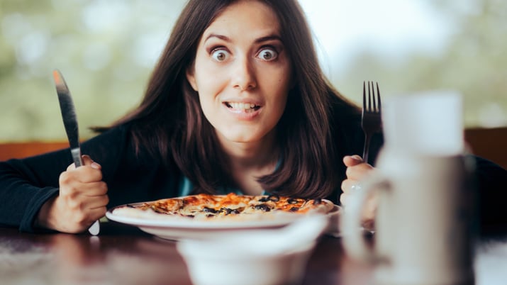 sitting at the table with fork and knife looking hungry