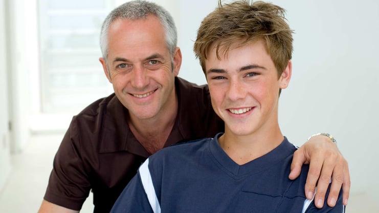 smiling teenage boy with his father