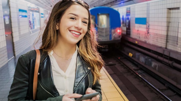 smiling teenage girl waiting for subway