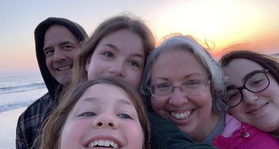 family selfie at the beach at sunset