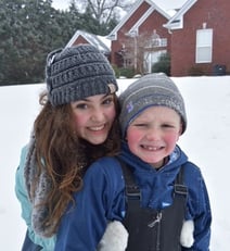 teen girl with young child in the snow