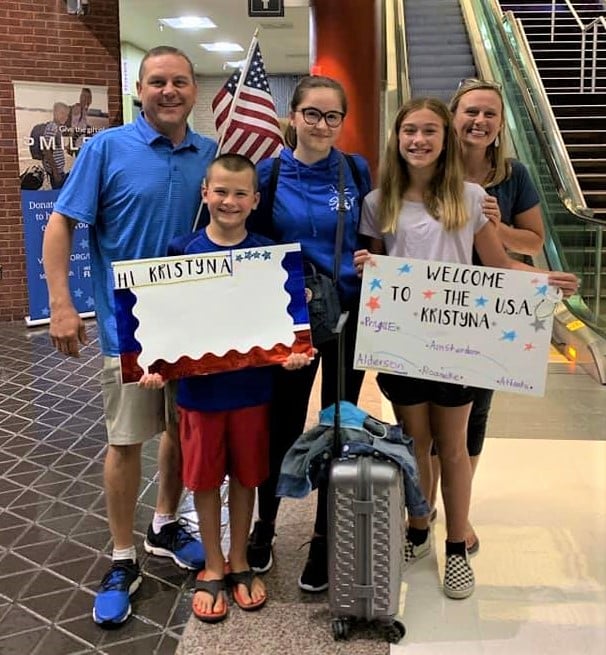 host family greeting exchange student at airport
