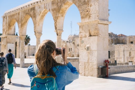 young woman visiting foreign ruins