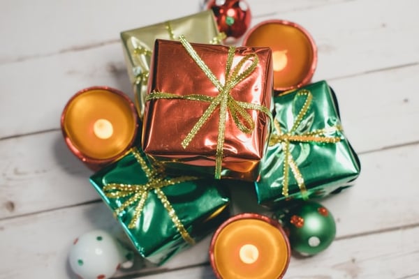 Christmas gifts wrapped in shiny red, gold and green paper