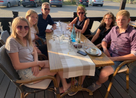 teenage american girl with Germany host family at restaurant