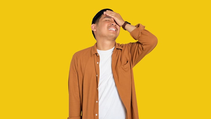 teenage boy with hand to head looking regretful