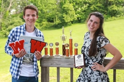 teenage-couple-holding-awards-from-highschool