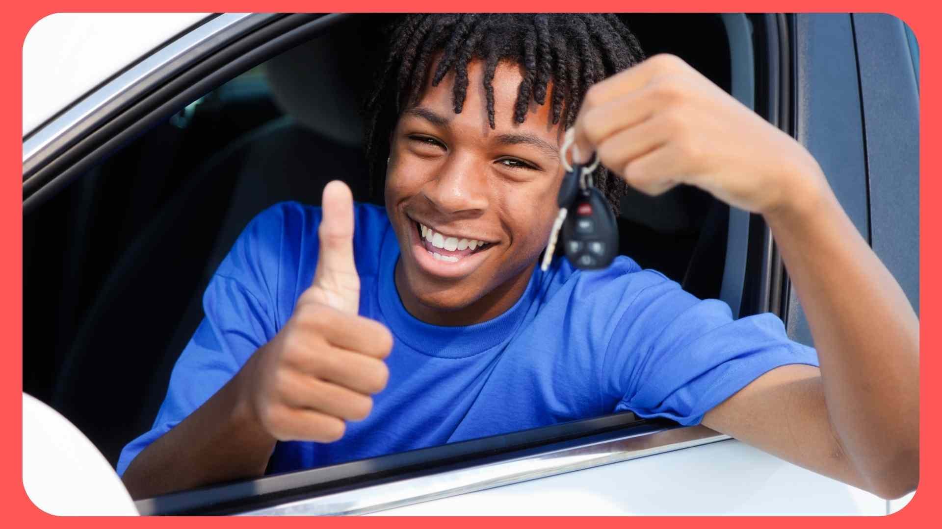 teenager boy with keys in drivers seat