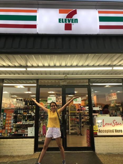 teenager in front of 7Eleven with arms to the sky