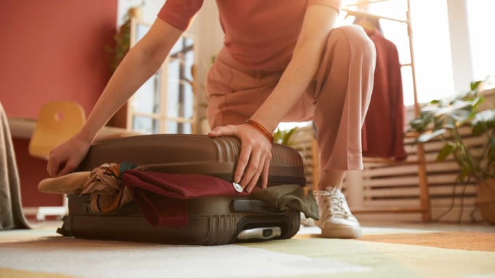 teenager packing suitcase