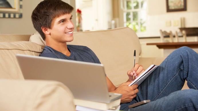 teenager sitting on the sofa with laptop