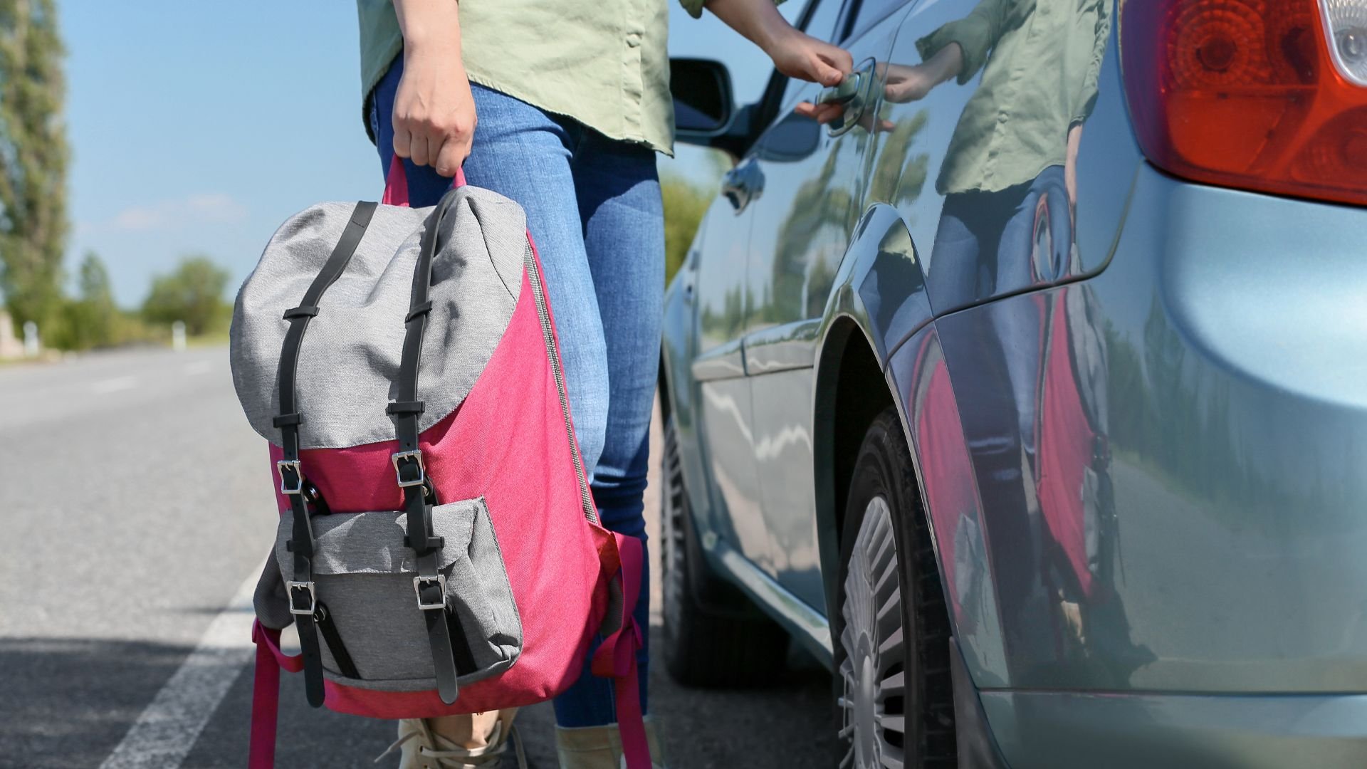 teenager with backpack getting into the car