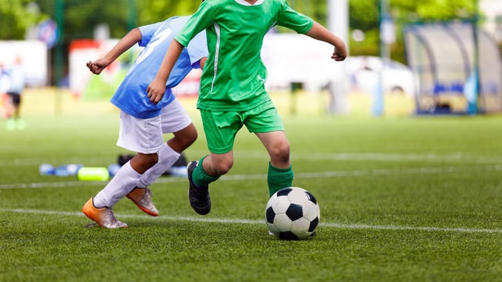 teenagers playing soccer