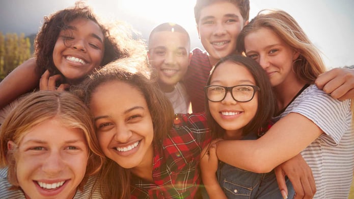 teenagers smiling and hugging each other